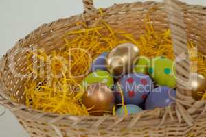 Various Easter eggs in wicker basket