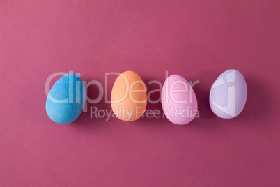 Easter eggs arranged on pink background