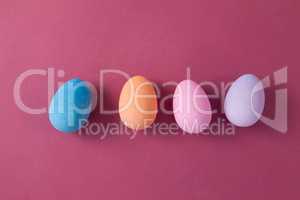 Easter eggs arranged on pink background