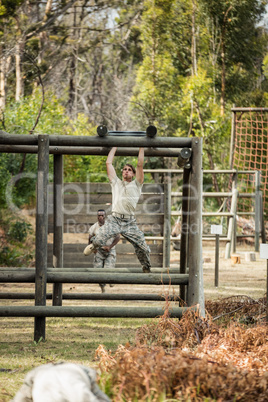 Soldier climbing monkey bars