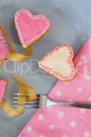 Heart shape gingerbread cookies, napkin and fork kept on plate