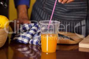 Male staff putting straw in a glass