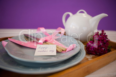 Happy mothers day card with teapot on wooden tray