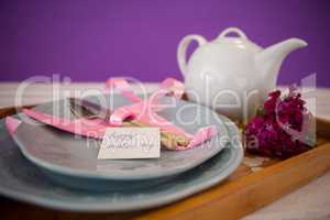 Happy mothers day card with teapot on wooden tray