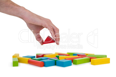 Hand arranging building blocks