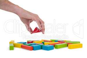 Hand arranging building blocks