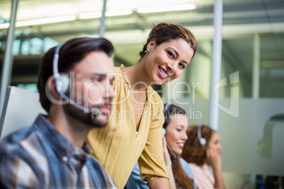 Portrait of smiling female executive at desk