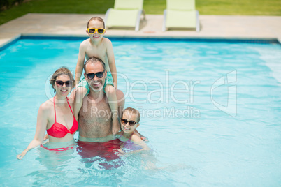 Happy parents and kids in pool