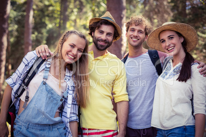 Group of friends standing together with arm around