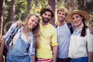 Group of friends standing together with arm around