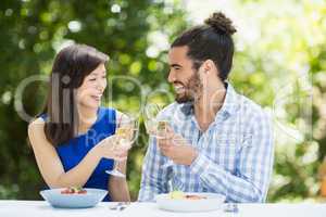 Couple toasting glasses of wine in a restaurant