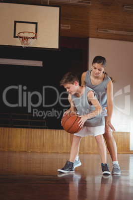 School kids playing basketball