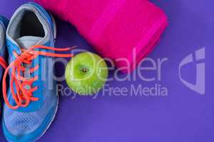 Sneakers, apple, towel and measuring tape