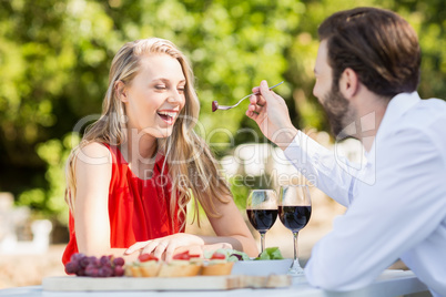 Man feeding a woman with fork