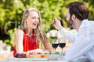 Man feeding a woman with fork