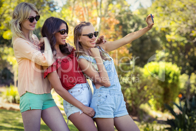 Friends taking selfie with mobile phone