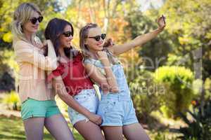 Friends taking selfie with mobile phone