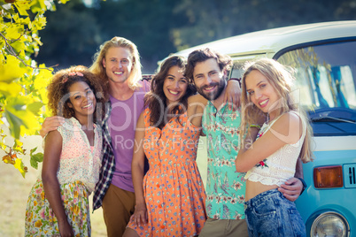 Group of friends standing together near campervan