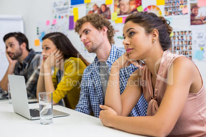Tired executives listening presentation in conference room
