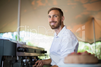 Waiter preparing espresso at restaurant