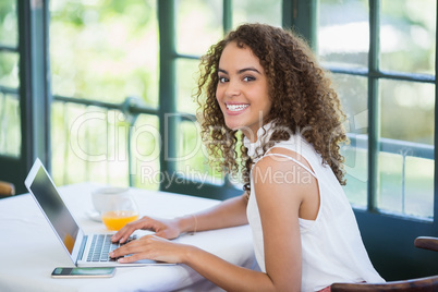 Woman using laptop in a restaurant