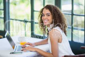 Woman using laptop in a restaurant