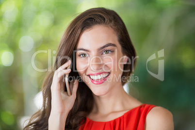 Woman smiling while talking on her mobile phone