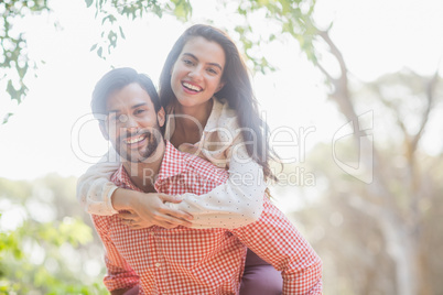 Man giving piggyback ride to woman