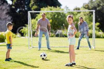 Family playing football together at the park