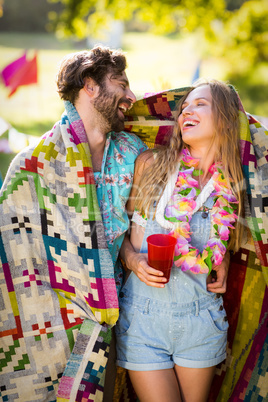 Couple wrap themselves in blanket