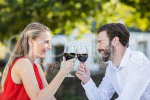 Couple toasting glasses of wine in a restaurant