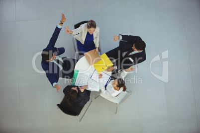 Businesspeople making victory sign in meeting
