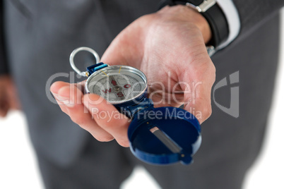 Mid section of businessman holding compass