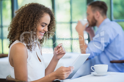 Woman using digital tablet in a restaurant