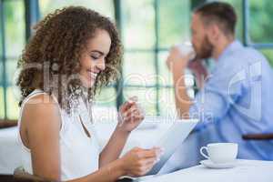 Woman using digital tablet in a restaurant