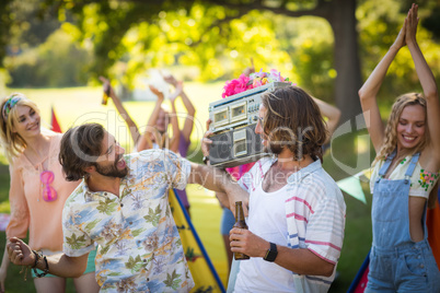 Group of friends having fun together at campsite