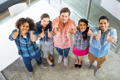 High angle view of happy executives showing thumbs up