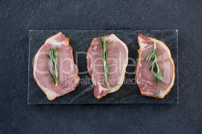 Sirloin chops and rosemary herb on slate plate