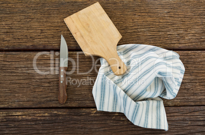 Knife, wooden tray and table cloth