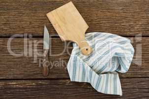 Knife, wooden tray and table cloth