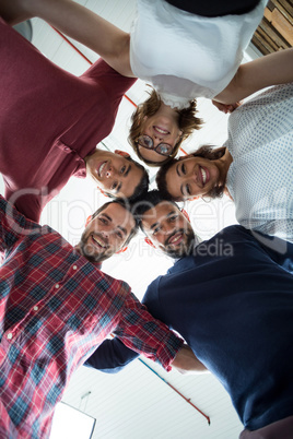 Team of businesspeople forming huddle