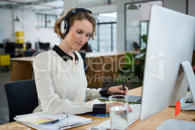 Female graphic designer working at desk