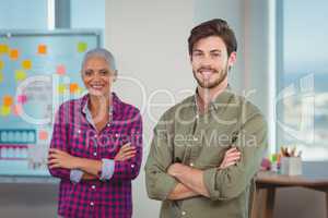 Portrait of business executives standing with arms crossed