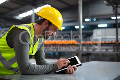 Factory worker using digital tablet