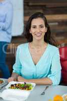 Smiling business executive having meal in office