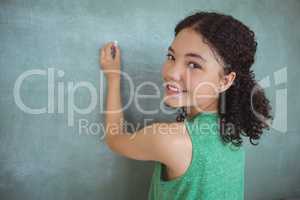 Portrait of schoolgirl pretending to be a teacher in classroom