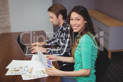 Male and graphic designers working together in conference room
