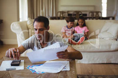 Man holding a bill in living room