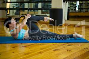 Beautiful woman performing stretching exercise