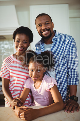 Portrait of parents and daughter in kitchen